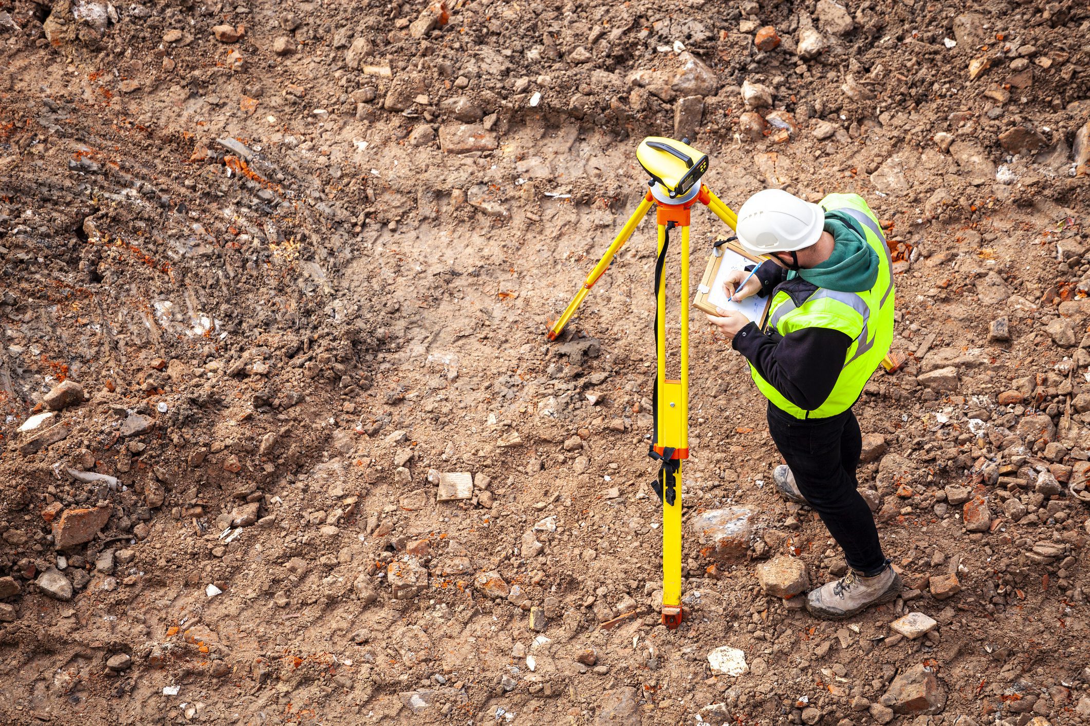 Man in safety gear surveying land