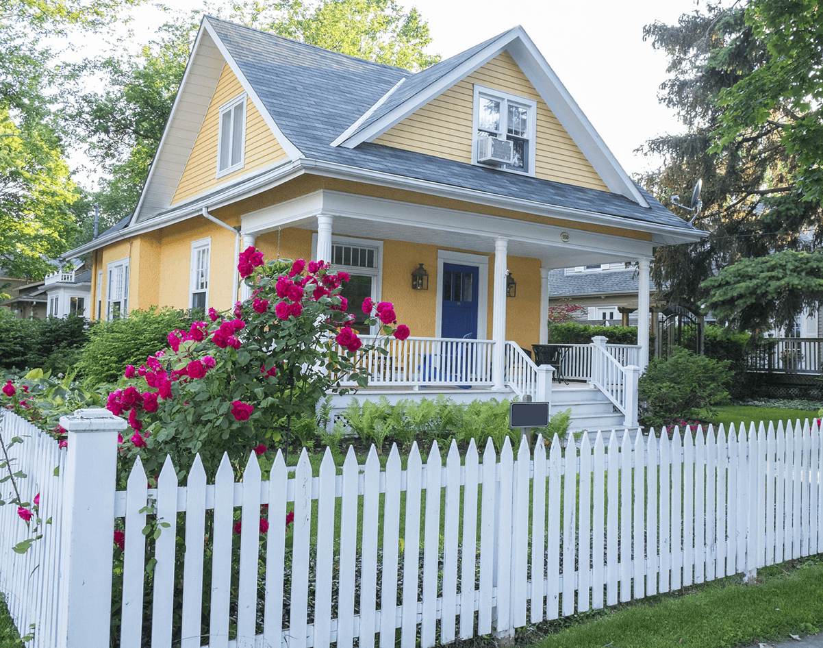 Charming cottage with blooming red roses