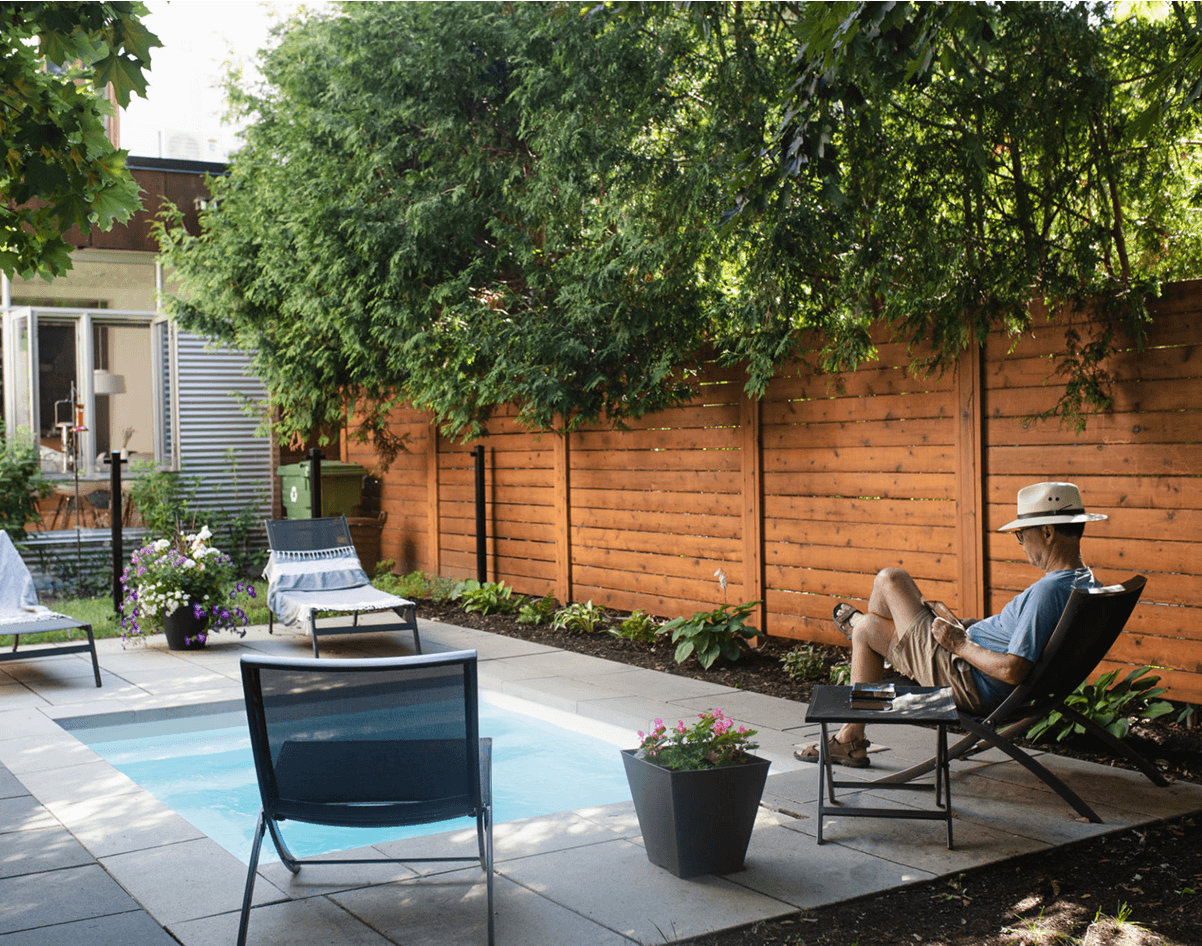 Man lounging by small backyard pool