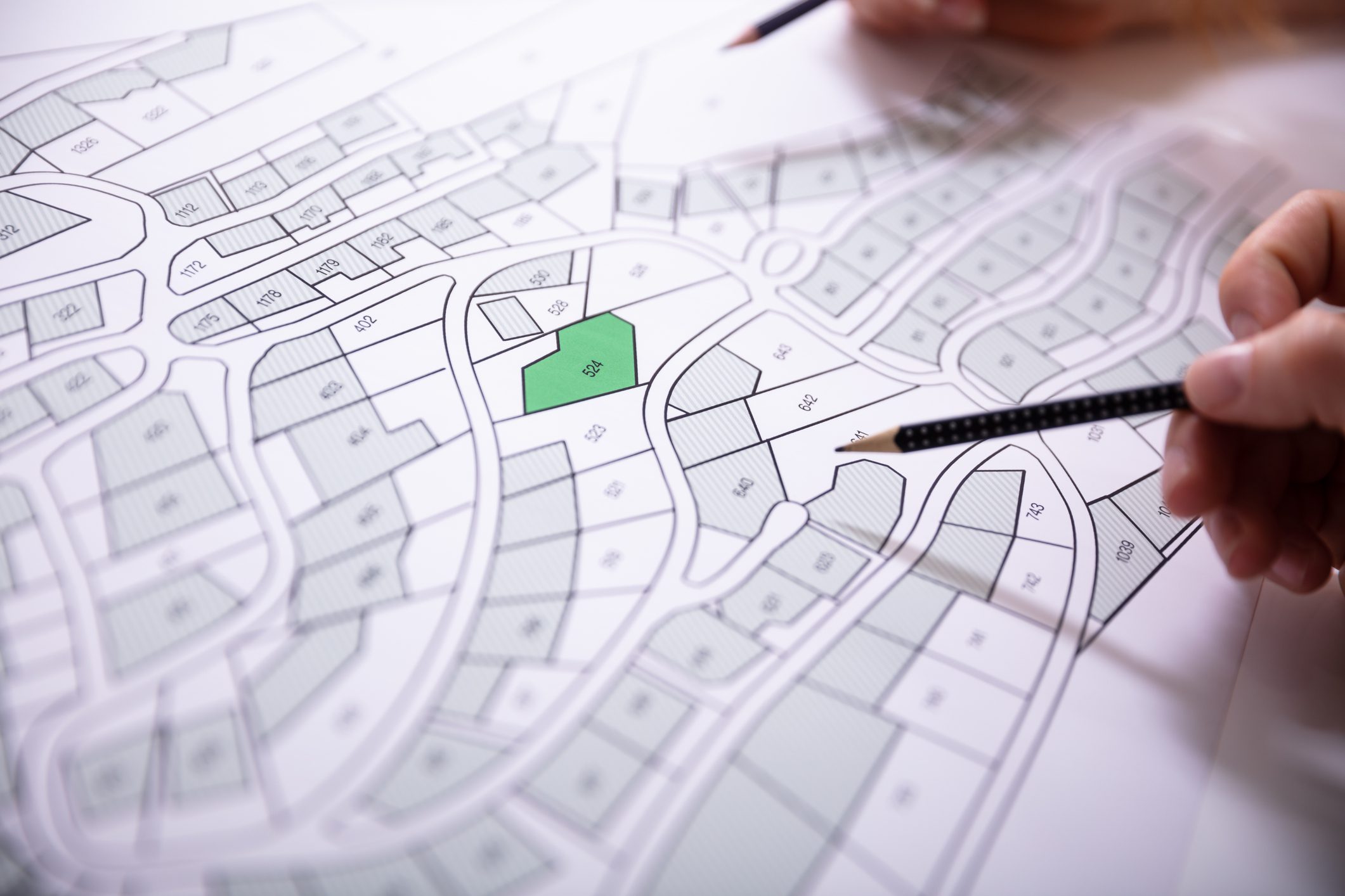 Hands pointing at urban planning map