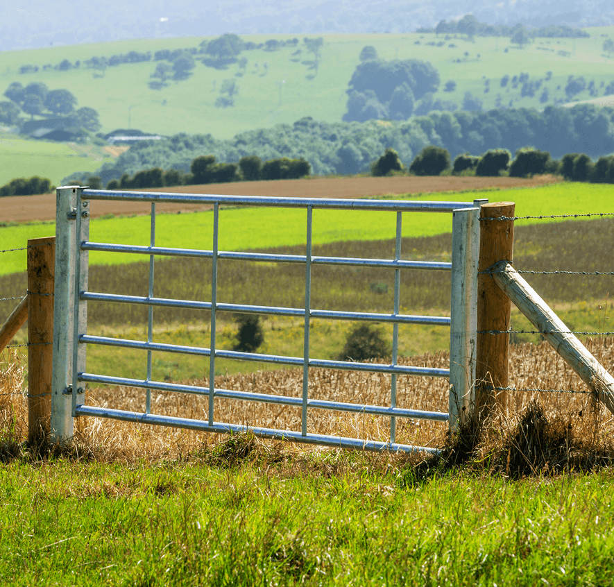 Farm gate in rural landscape